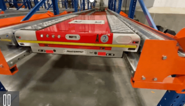 Pallet shuttle system moving through warehouse racking